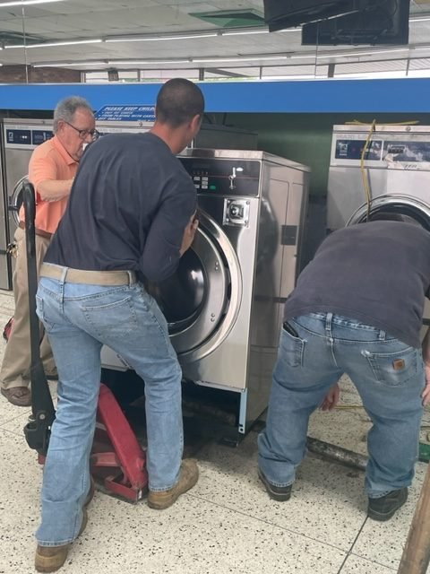 Large-capacity commercial washers at Tubs and Tumblers laundromat