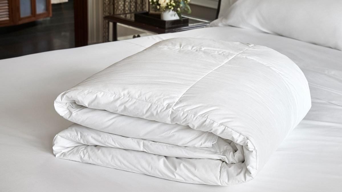 Freshly washed king size comforter neatly folded after professional laundering