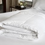 Freshly washed king size comforter neatly folded after professional laundering
