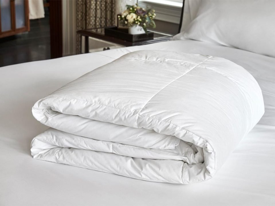 Freshly washed king size comforter neatly folded after professional laundering