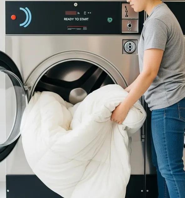 King size comforter being washed in a large commercial washer at Tubs and Tumblers in Wayne