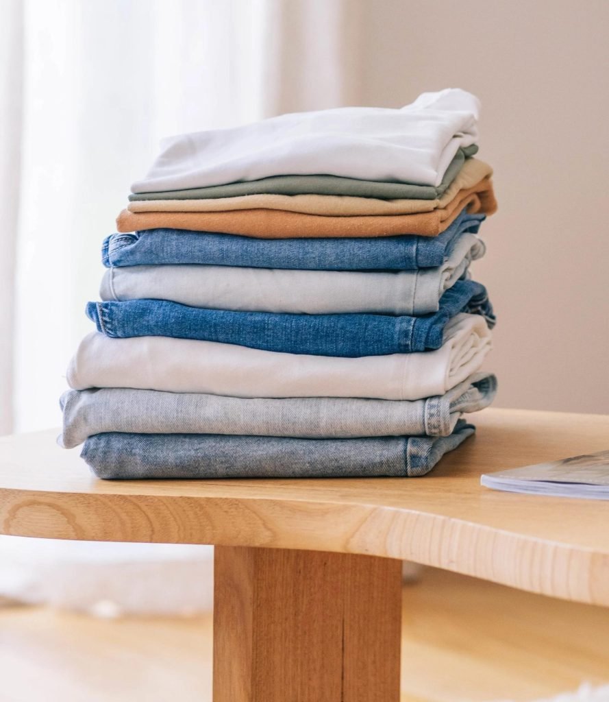 Neatly folded clean laundry prepared for customer pickup at Tubs and Tumblers.