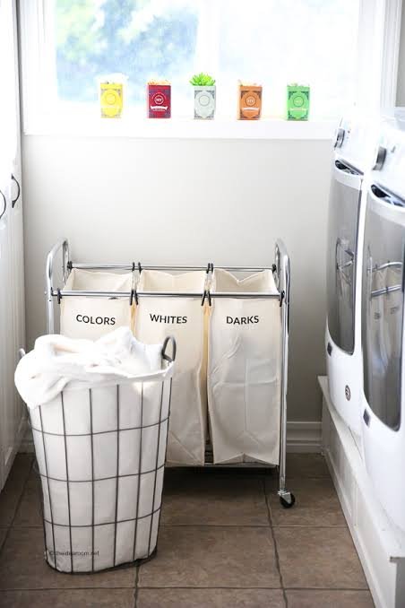 Sorting white colored and dark laundry before washing